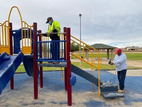 City staff preforming maintenance of recreational area at Bienestar 9B